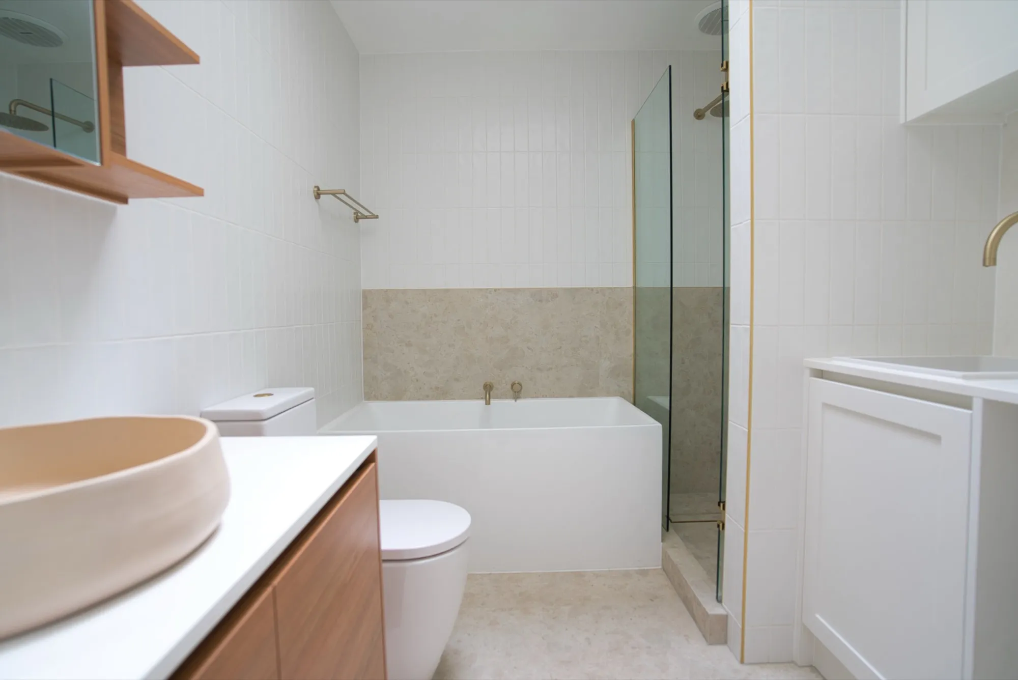 Completed bathroom renovation with bath, walk-in shower and timber vanity