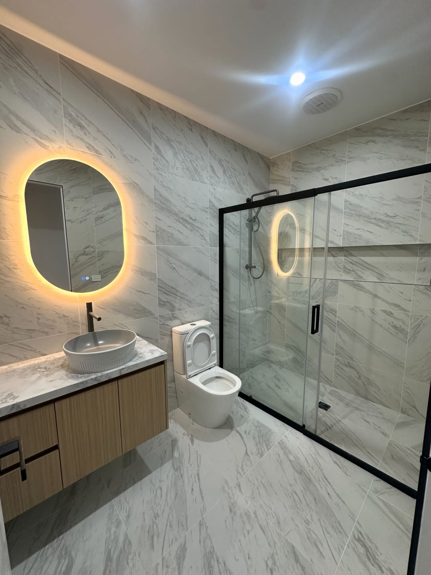 Marble LED bathroom with single vanity
