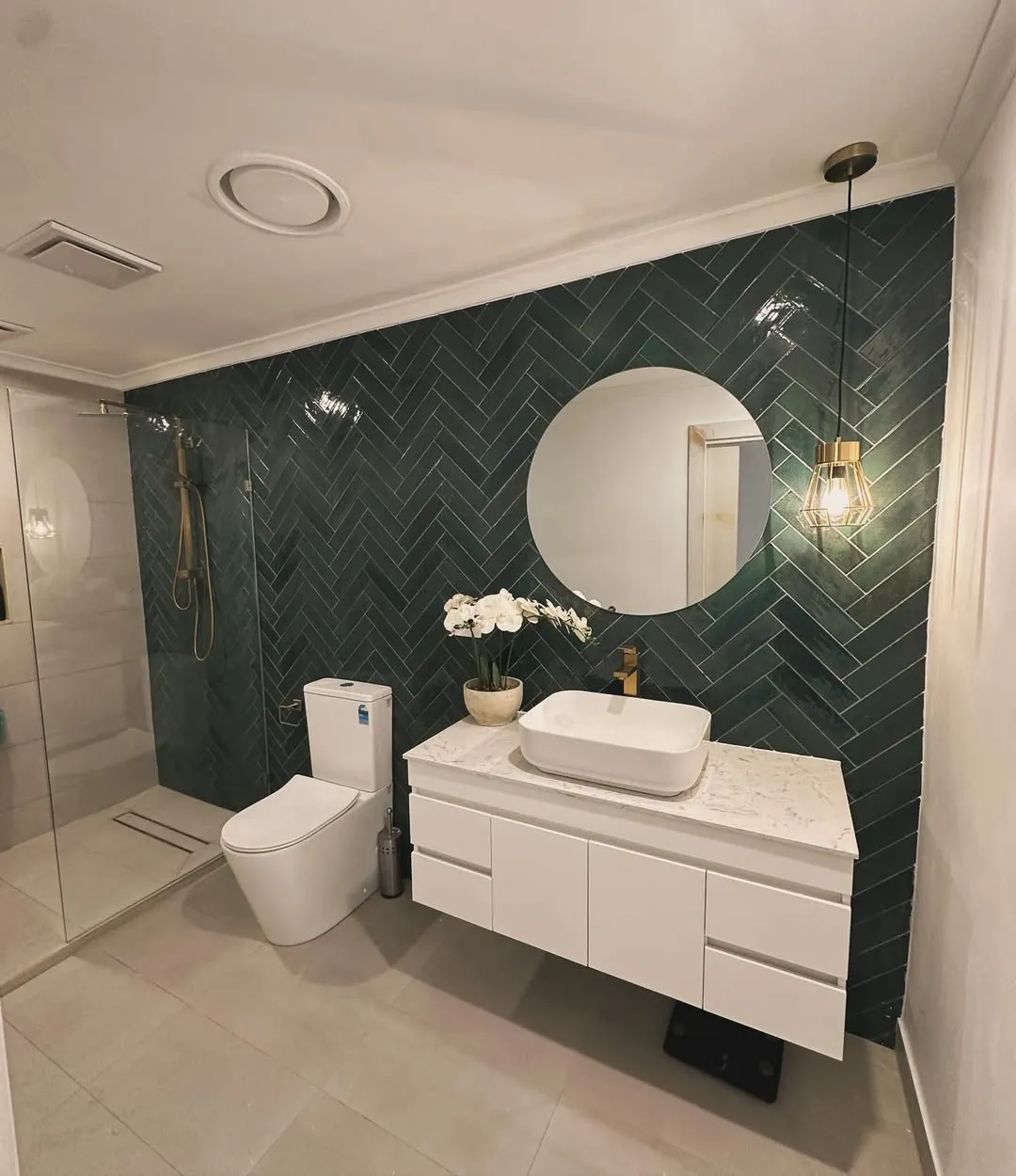 Bathroom with emerald herringbone feature wall